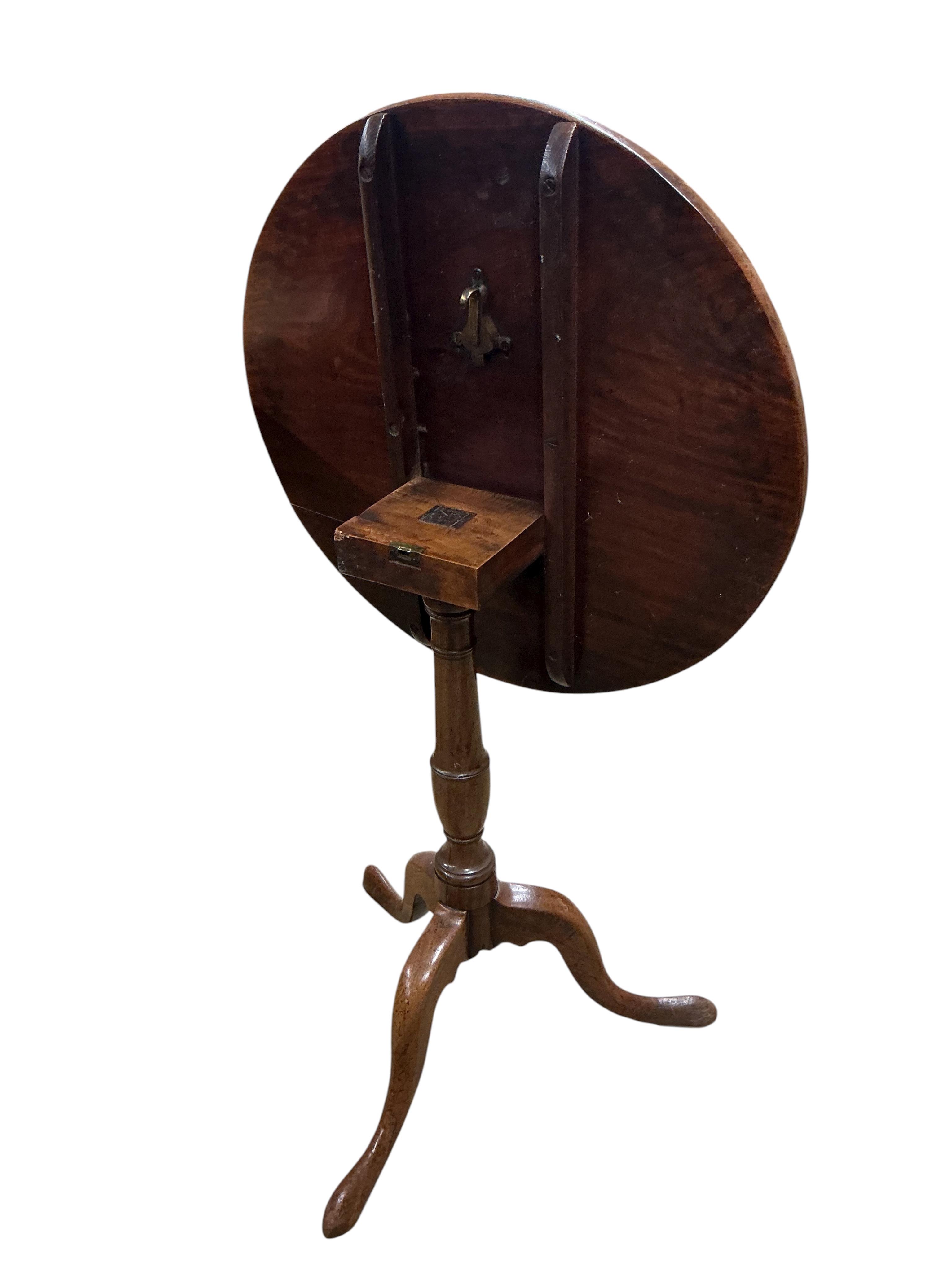 An early 19th century circular mahogany tilt top tripod tea table, diameter 59cm, height 71cm, together with an oak oval occasional table, adapted